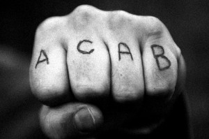 A fist with ACAB tattooed on the knuckles