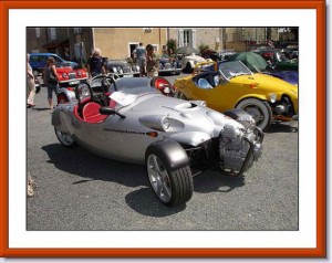 Both cars parked on gravel at a Morgan owners meet.