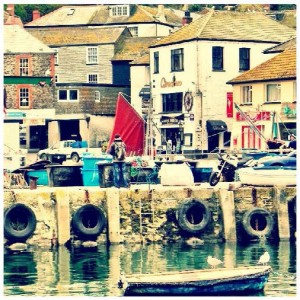 A bike parked on the harbour wall of Penzance harbour.